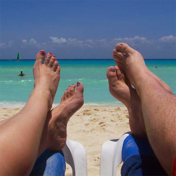 Tim and Faith relaxing on a beach.